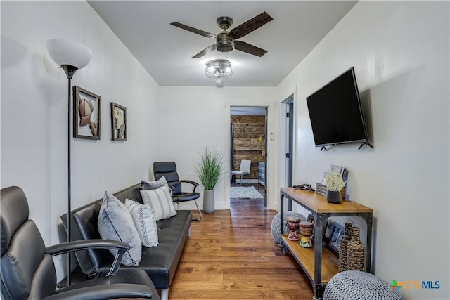 living room featuring ceiling fan and hardwood / wood-style floors