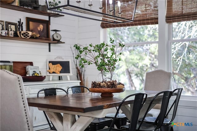 dining room with wood walls