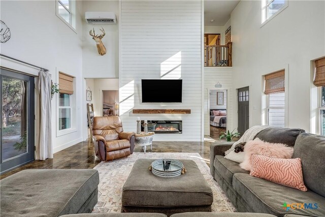 kitchen with a center island with sink, white cabinets, and pendant lighting