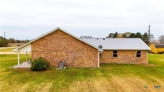 back of property featuring cooling unit, a lawn, and a patio area