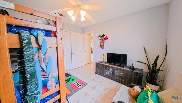 interior space featuring light tile patterned floors and ceiling fan