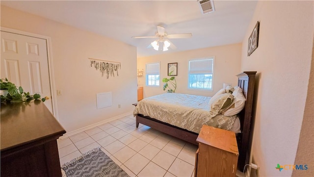 tiled bedroom featuring ceiling fan