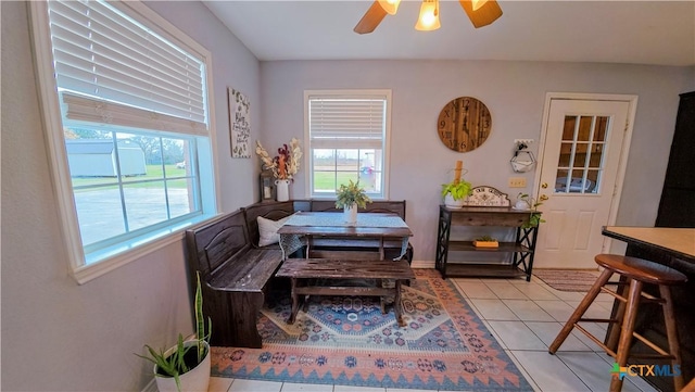 dining room with light tile patterned floors and ceiling fan