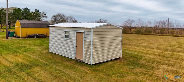 view of outbuilding featuring a lawn