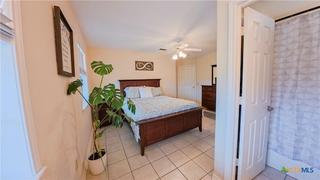 bedroom featuring light tile patterned floors and ceiling fan