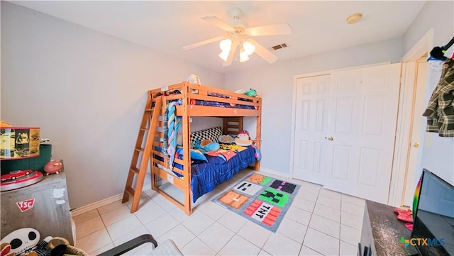 tiled bedroom featuring ceiling fan