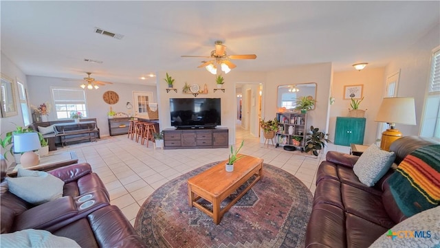 living room with light tile patterned floors and ceiling fan