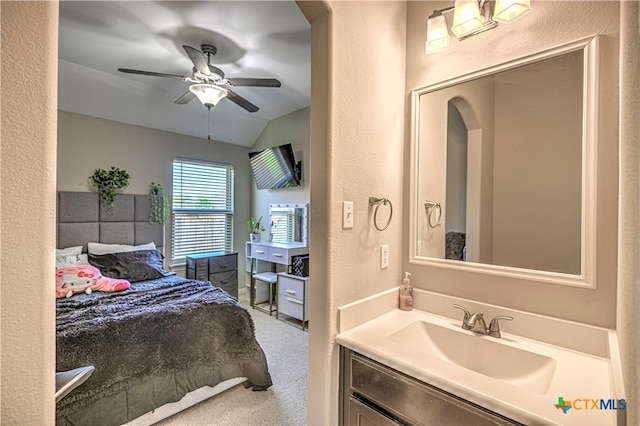 carpeted bedroom with lofted ceiling, sink, and ceiling fan