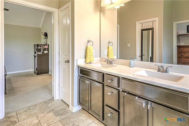 bathroom with ornamental molding and vanity