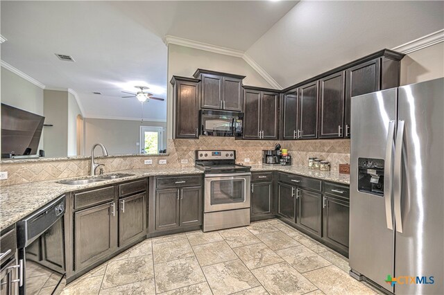 kitchen featuring black appliances, sink, lofted ceiling, and light stone countertops