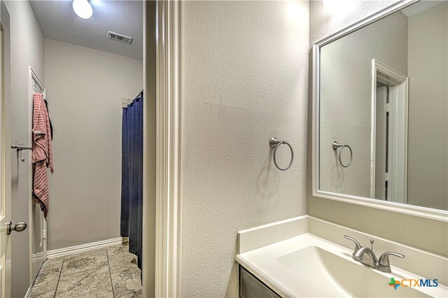 bathroom with vanity and a shower with shower curtain