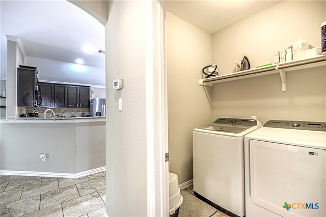 clothes washing area with washing machine and dryer