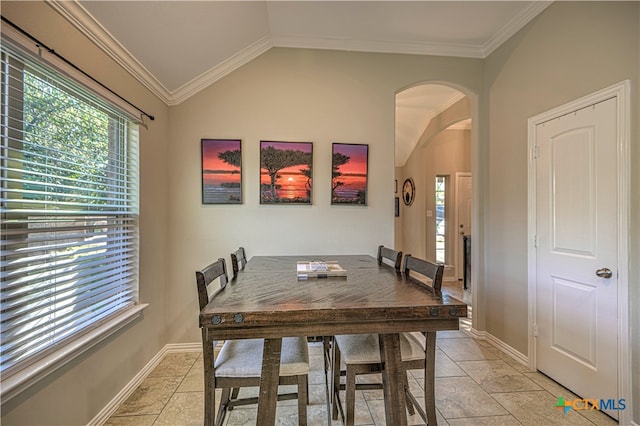 dining space with ornamental molding and lofted ceiling