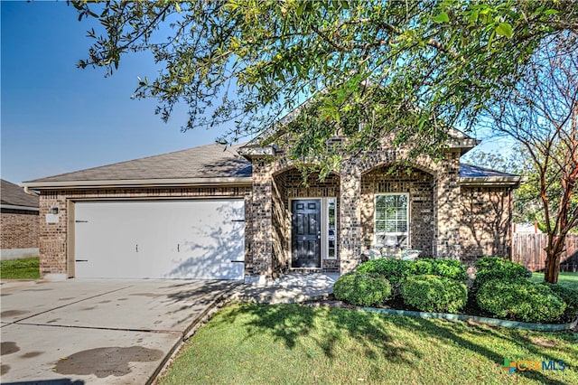 view of front of house with a front lawn and a garage