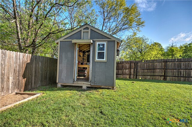 view of outdoor structure featuring a lawn