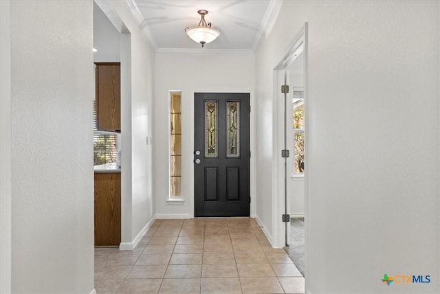 7778 Little Deer Trl, Georgetown, TX 78628 - doorway with light tile patterned floors, baseboards, and crown molding