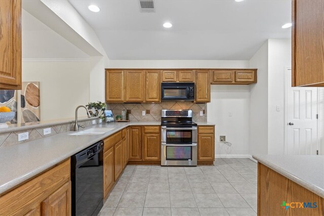 7778 Little Deer Trl, Georgetown, TX 78628 - kitchen featuring a sink, brown cabinets, black appliances, visible vents, and decorative backsplash