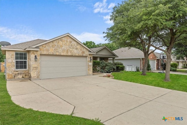 7778 Little Deer Trl, Georgetown, TX 78628 - single story home with a front lawn, stone siding, a garage, and driveway