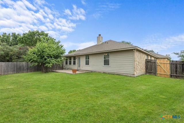7778 Little Deer Trl, Georgetown, TX 78628 - back of house featuring a lawn, a chimney, a patio, and a fenced backyard