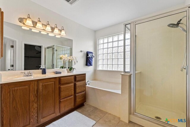 7778 Little Deer Trl, Georgetown, TX 78628 - full bath featuring a stall shower, visible vents, tile patterned floors, a garden tub, and vanity