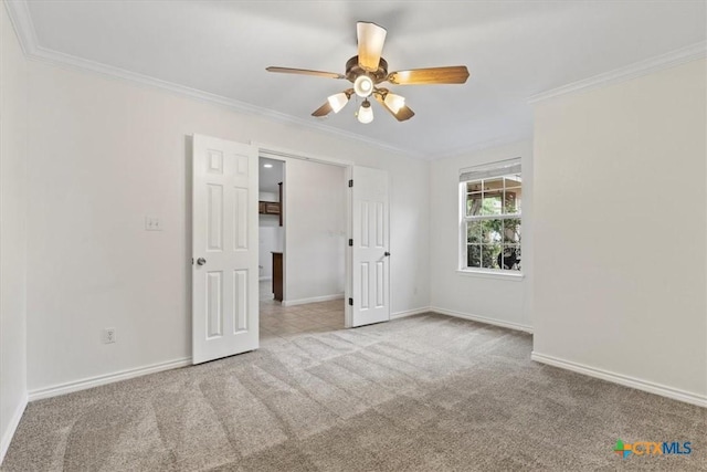 7778 Little Deer Trl, Georgetown, TX 78628 - carpeted spare room with crown molding, baseboards, and ceiling fan