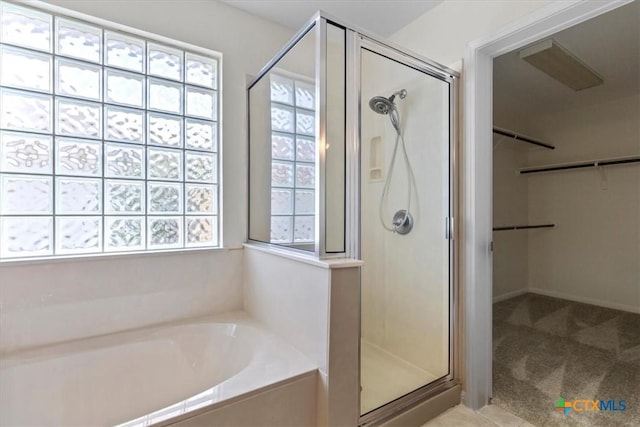 7778 Little Deer Trl, Georgetown, TX 78628 - full bathroom featuring a walk in closet, a garden tub, and a shower stall