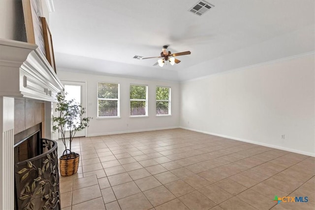 7778 Little Deer Trl, Georgetown, TX 78628 - unfurnished living room featuring baseboards, a tiled fireplace, ceiling fan, visible vents, and light tile patterned flooring