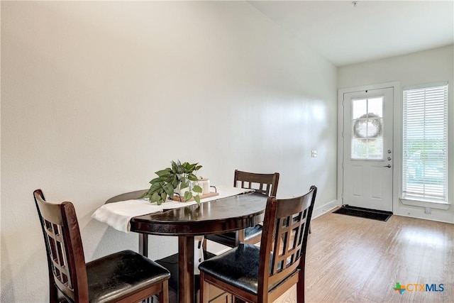 2400 Louis Henna Blvd Unit 305, Round Rock, TX 78664 - dining room with light wood-style floors and baseboards