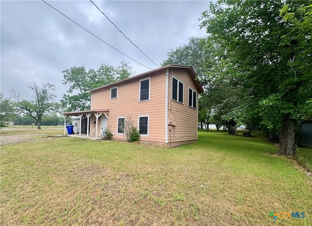 503 Dunn St, Yoakum, TX 77995 - back of house featuring a lawn