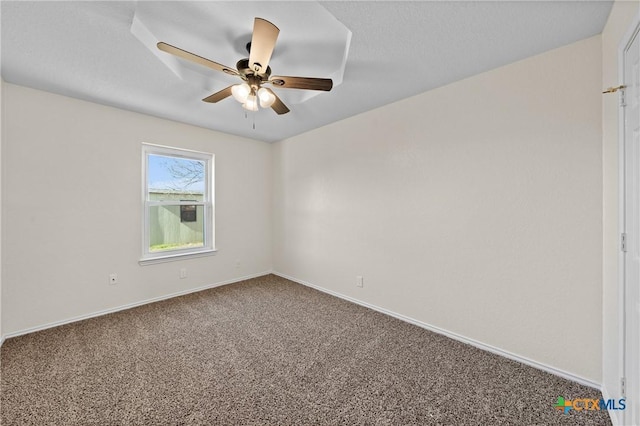 spare room featuring ceiling fan and carpet flooring