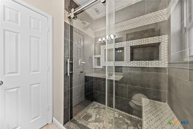 bathroom with a shower with door