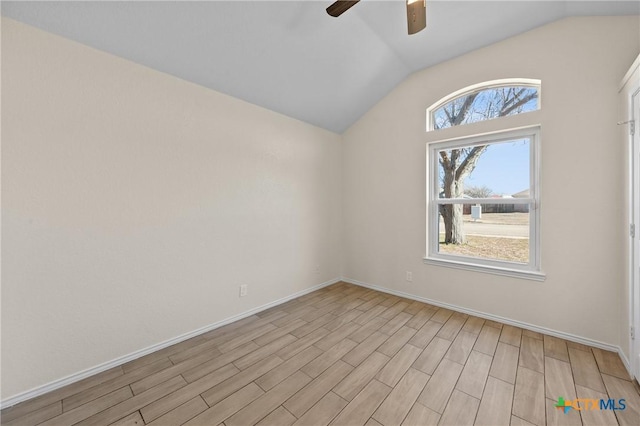 empty room with lofted ceiling, ceiling fan, and light hardwood / wood-style flooring