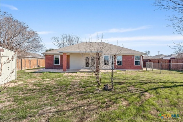 back of property featuring a storage shed, a lawn, and a patio area