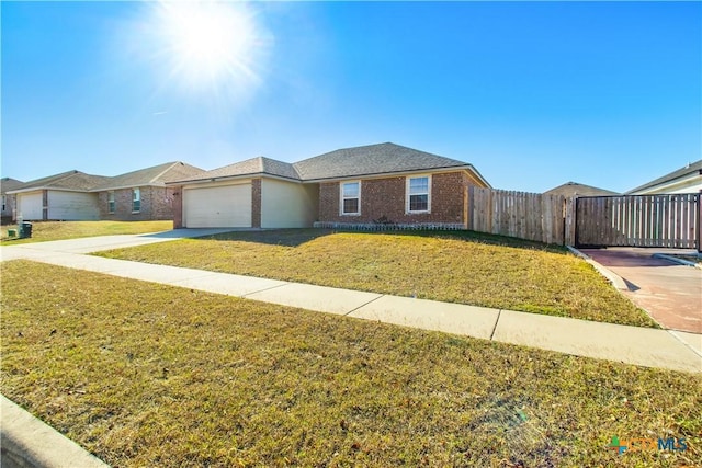 single story home featuring a garage and a front lawn