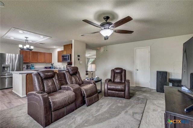 living room with light colored carpet, a textured ceiling, recessed lighting, and ceiling fan