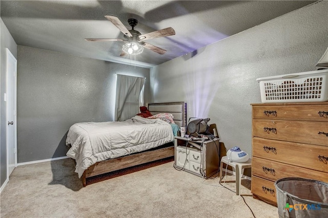 carpeted bedroom with a textured wall and ceiling fan