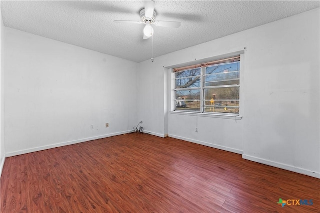 spare room with baseboards, a textured ceiling, a ceiling fan, and wood finished floors