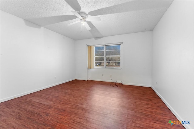 unfurnished room featuring a textured ceiling, wood finished floors, baseboards, and ceiling fan