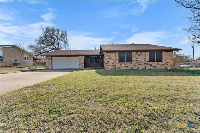 view of front of property featuring a front yard, fence, concrete driveway, a garage, and brick siding