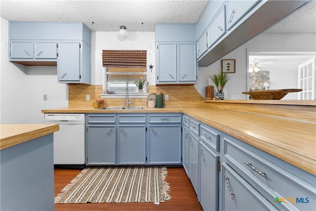 kitchen with backsplash, ceiling fan, white dishwasher, a textured ceiling, and a sink