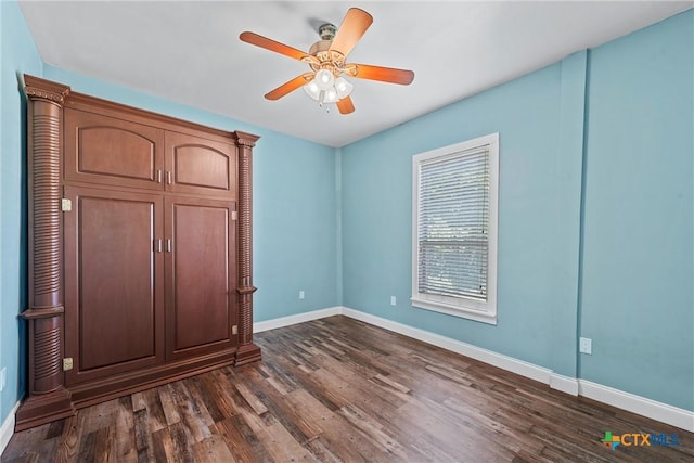 2212 Clay Ave, Waco, TX 76706 - unfurnished bedroom with baseboards, dark wood-style flooring, and ceiling fan