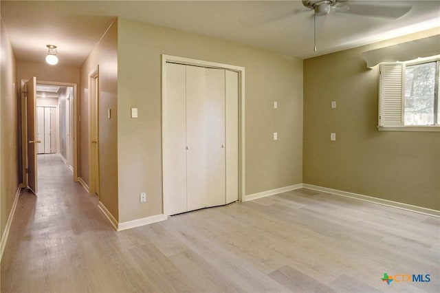 1705 Neuman St, Gonzales, TX 78629 - unfurnished bedroom with light wood-style floors, a closet, and a ceiling fan