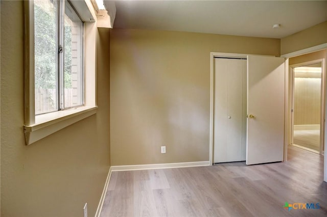 1705 Neuman St, Gonzales, TX 78629 - unfurnished bedroom with wood finished floors and a closet