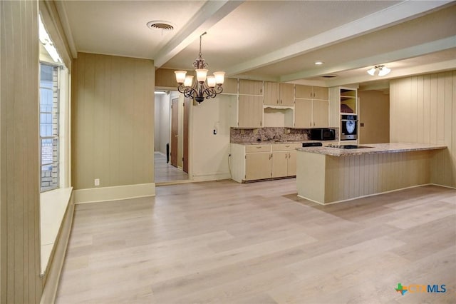 1705 Neuman St, Gonzales, TX 78629 - kitchen with beamed ceiling, light wood finished floors, a chandelier, black appliances, and a peninsula