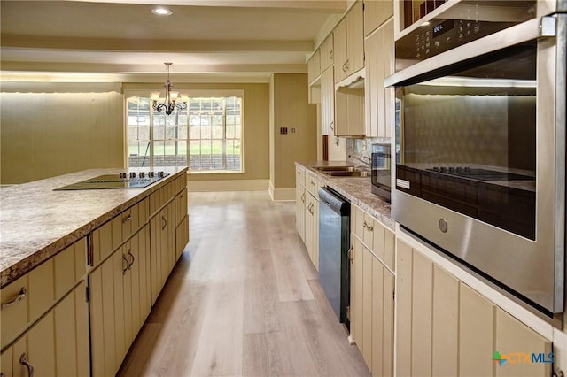 1705 Neuman St, Gonzales, TX 78629 - kitchen featuring light wood-type flooring, a chandelier, dishwasher, decorative backsplash, and light countertops