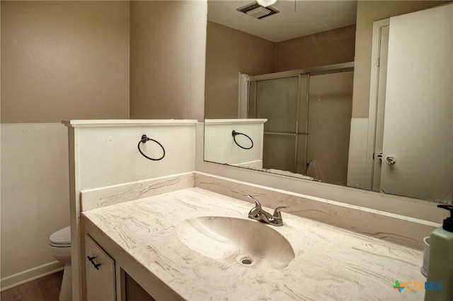 1705 Neuman St, Gonzales, TX 78629 - full bath featuring vanity, a shower with door, and wood finished floors