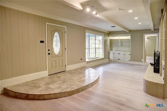 1705 Neuman St, Gonzales, TX 78629 - entrance foyer with beamed ceiling, light wood-style floors, track lighting, and wooden walls