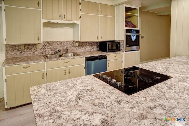 1705 Neuman St, Gonzales, TX 78629 - kitchen with appliances with stainless steel finishes, decorative backsplash, cream cabinets, and open shelves