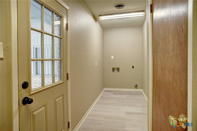 1705 Neuman St, Gonzales, TX 78629 - laundry room with electric dryer hookup, light wood-type flooring, and hookup for a washing machine