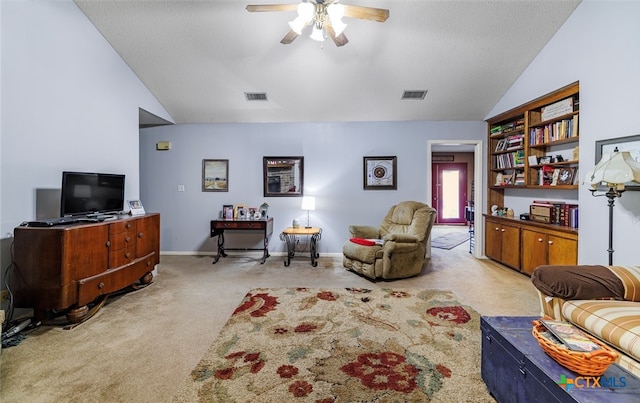 carpeted living room featuring a textured ceiling, ceiling fan, and lofted ceiling